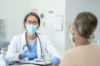 Doctor and patient wearing masks